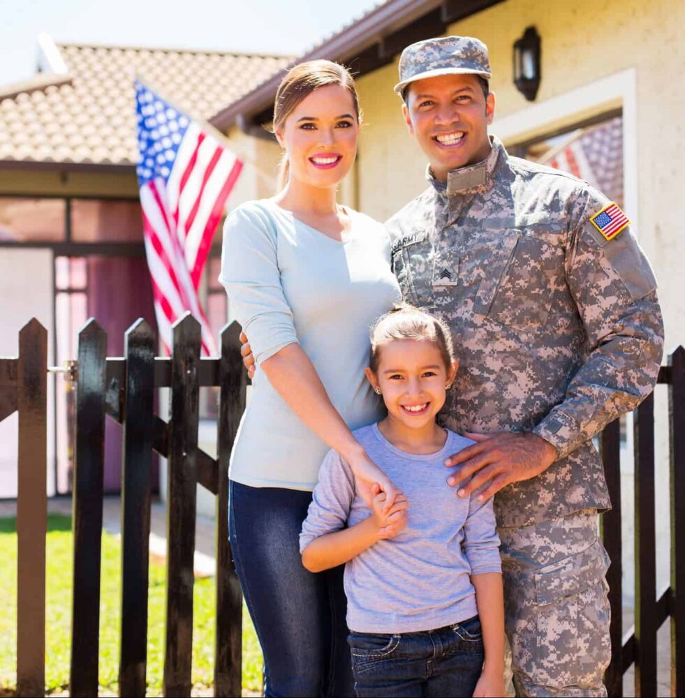 happy american soldier reunited with family outside their home